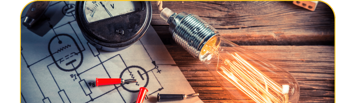 żarówka, kartka z rysunkiem obwodów i Voltomierz